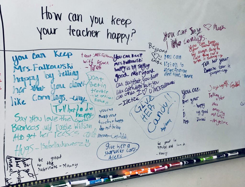 A photo of a whiteboard with student answers to the question. "How can you keep your teacher happy?"